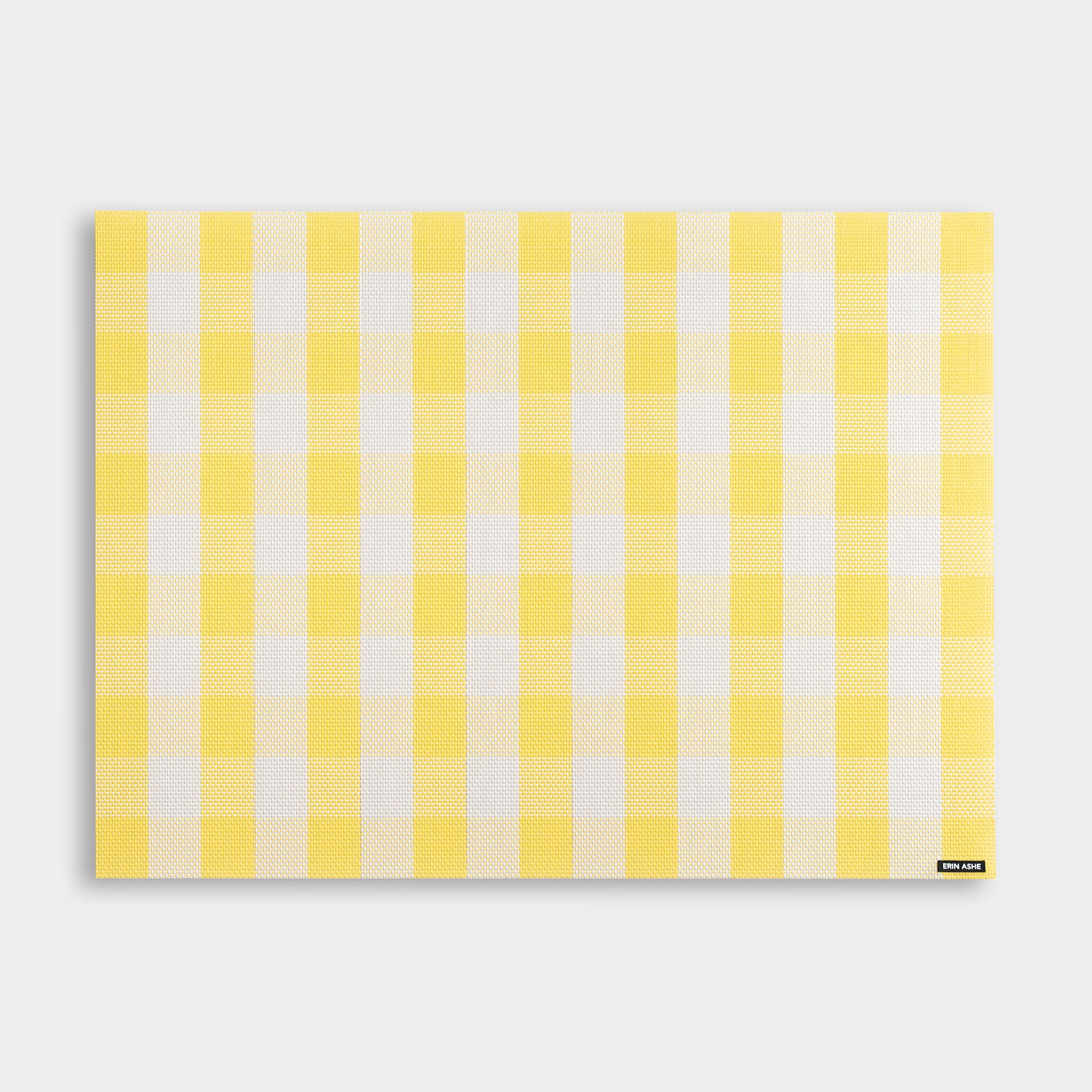 Rectangular woven vinyl placemat with yellow and white buffalo check pattern