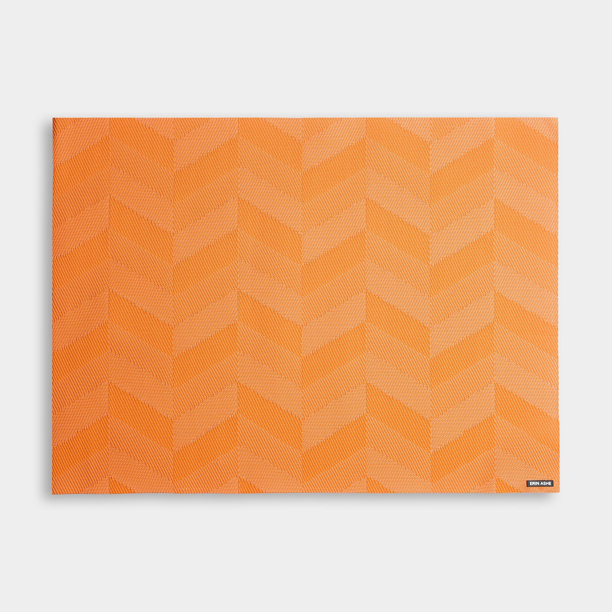 Rectangular woven vinyl placemat with tangerine orange chevron pattern