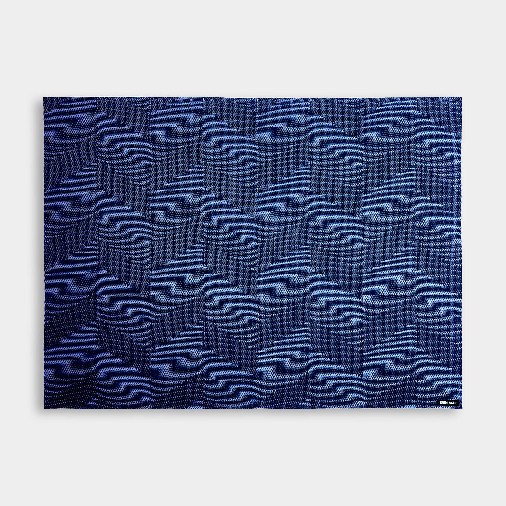 Rectangular woven vinyl placemat with blue chevron pattern
