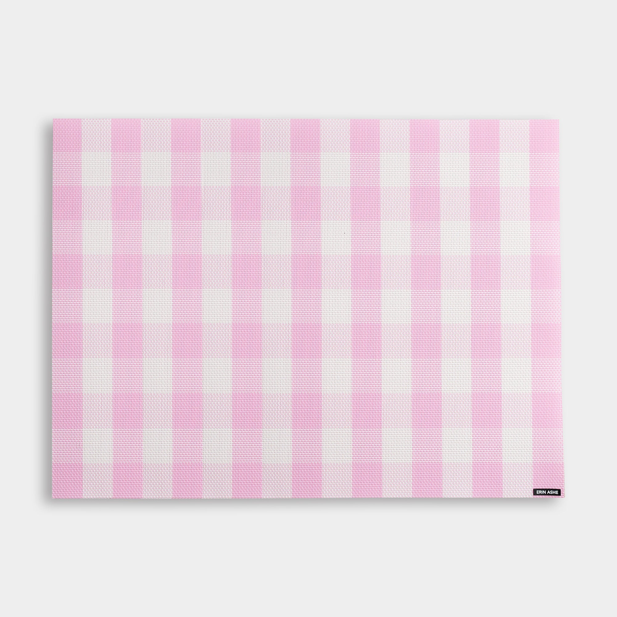 Rectangular woven vinyl placemat with pink and white buffalo check pattern