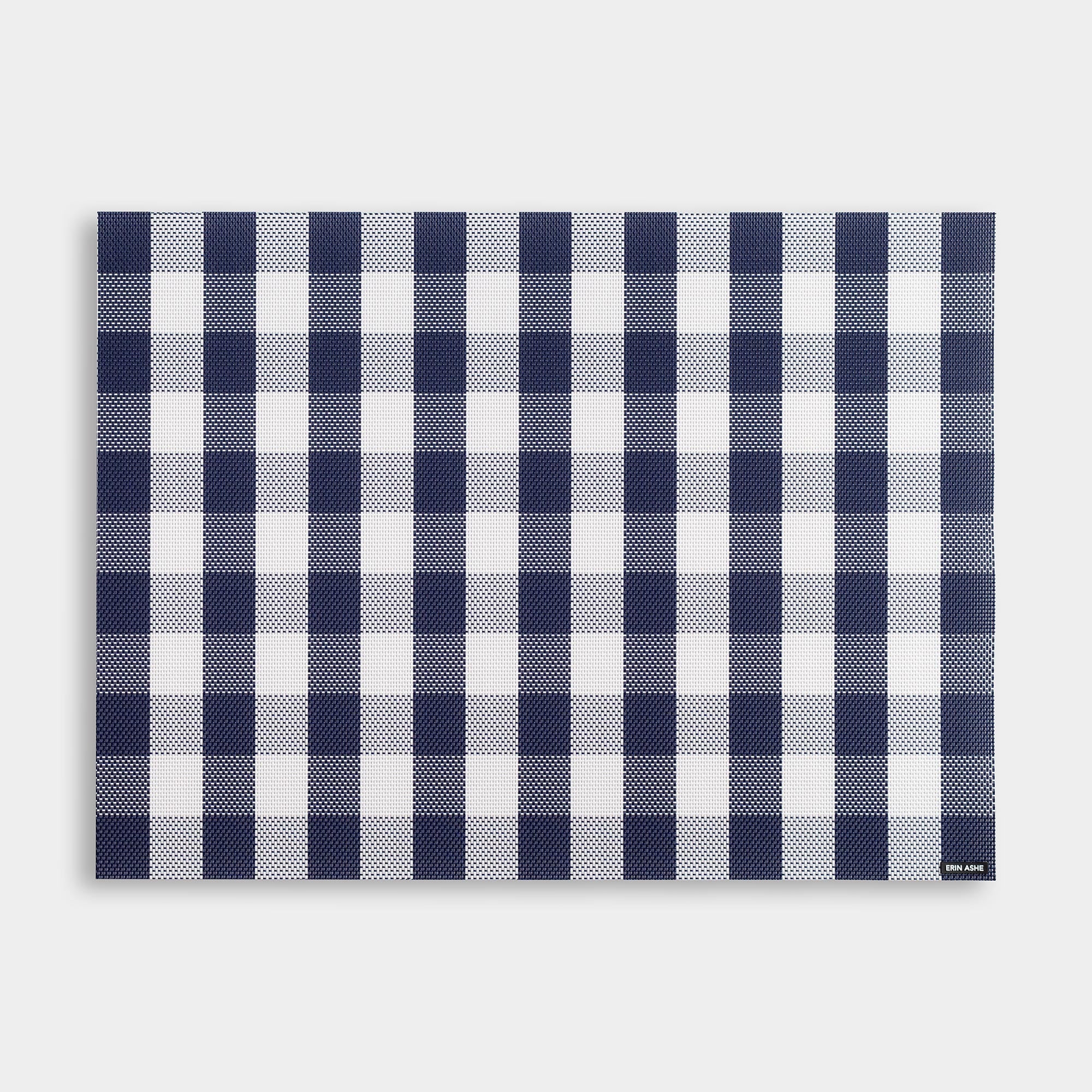 Rectangular woven vinyl placemat with navy blue and white buffalo check pattern