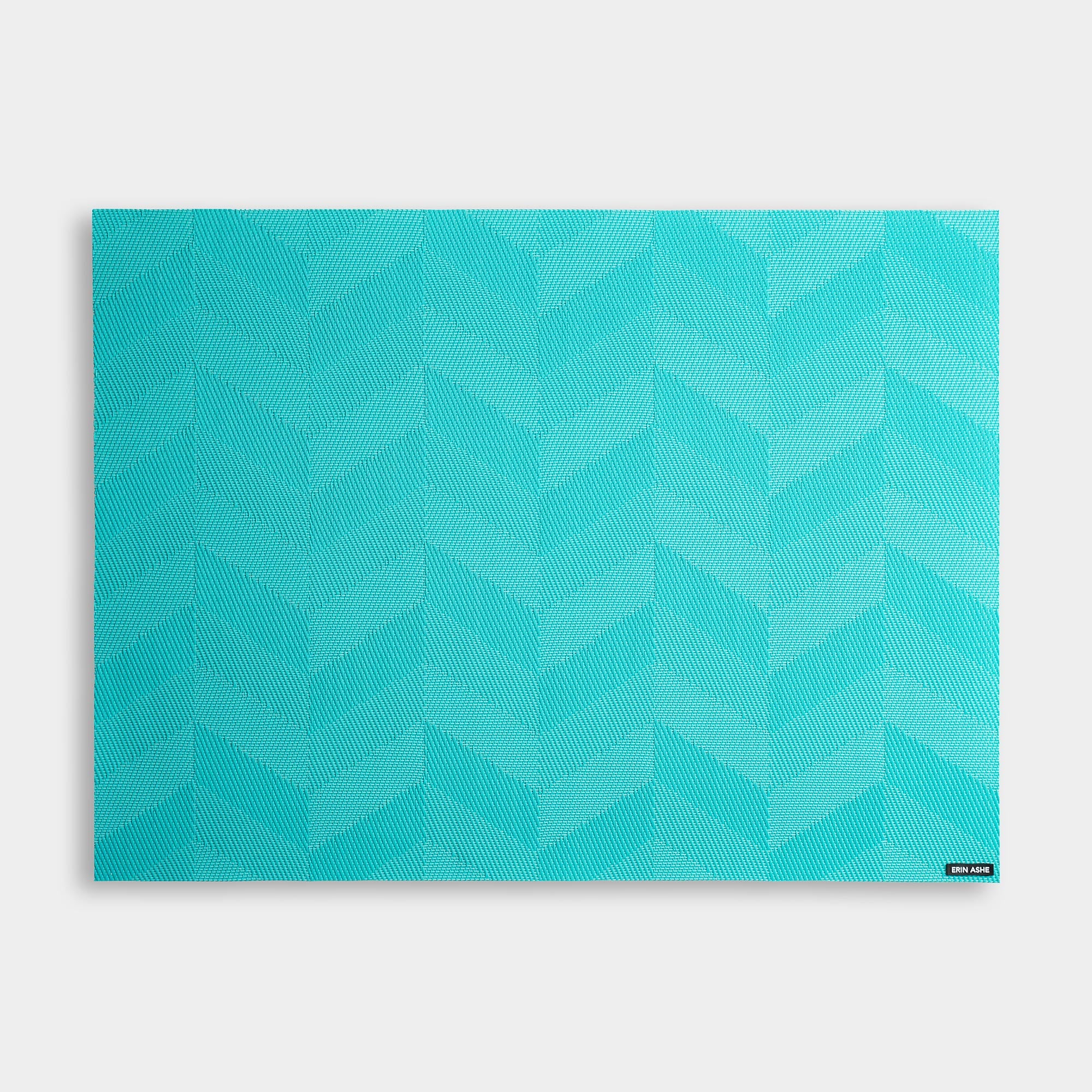 Rectangular woven vinyl placemat with aqua blue chevron pattern