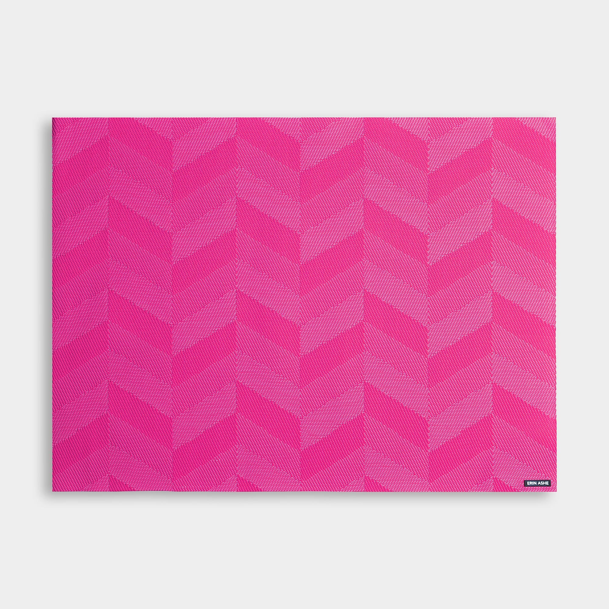 Rectangular woven vinyl placemat with bright pink chevron pattern