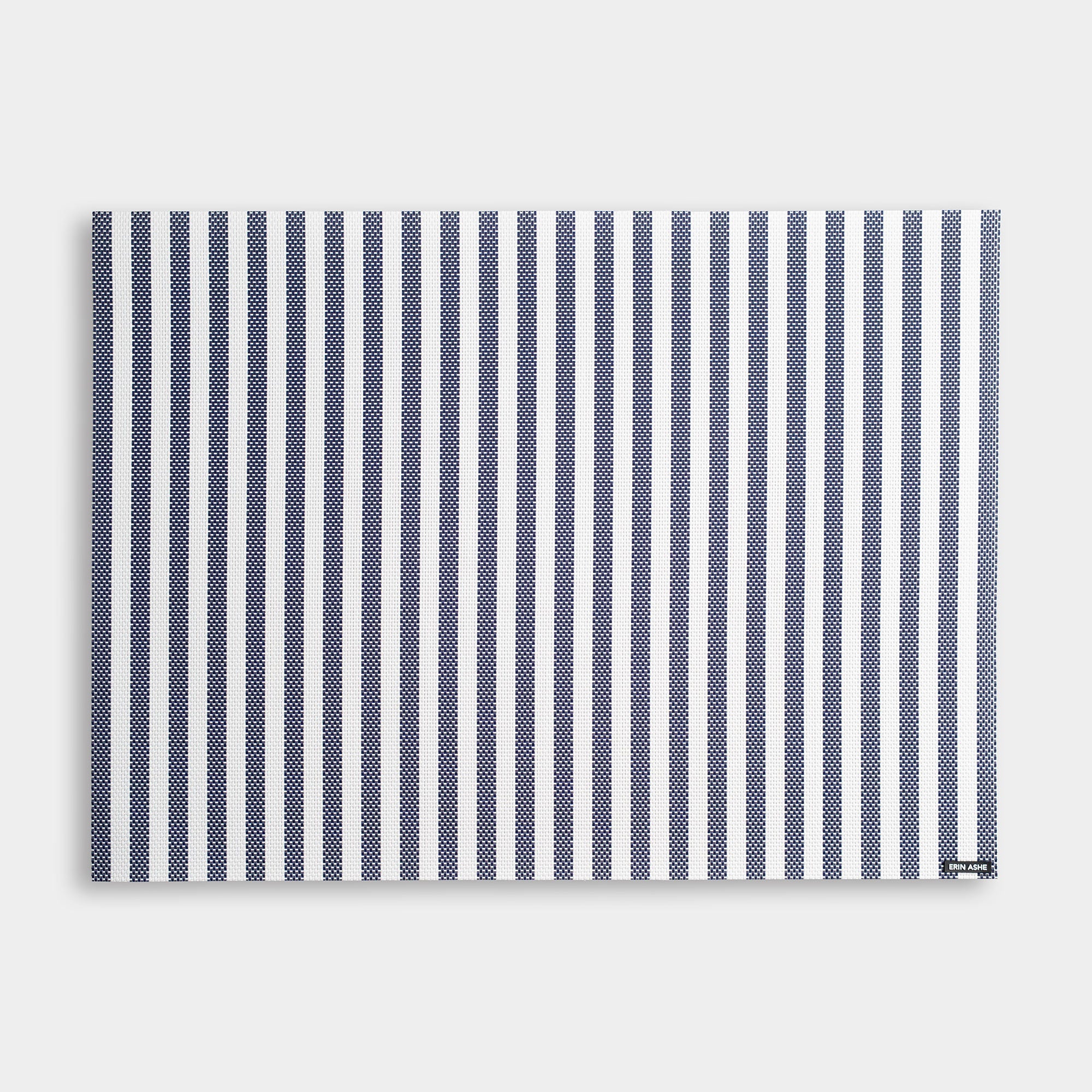 Rectangular woven vinyl placemat with navy blue and white stripes